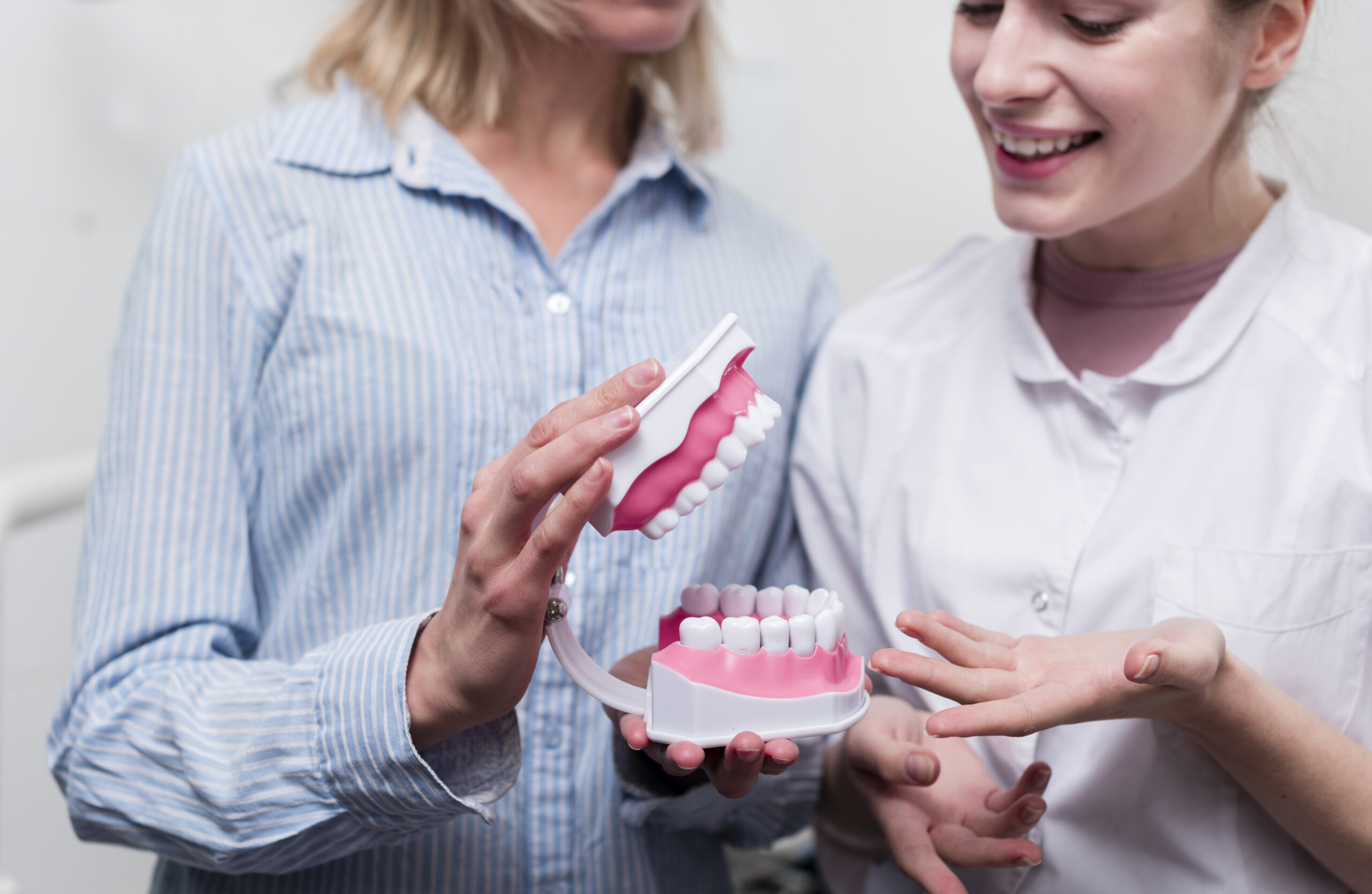 A person cleaning their dentures to prevent denture stomatitis with proper oral hygiene.